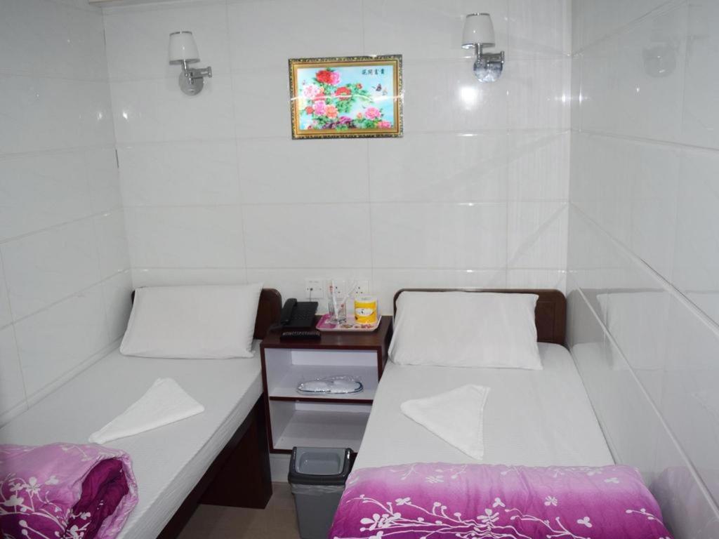 Postel nebo postele na pokoji v ubytování Pay-Less Guesthouse (7/F A9)