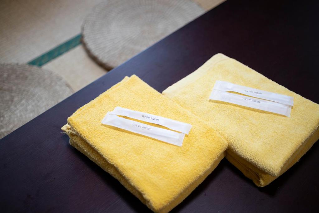 two white napkins sitting on top of a table at kamekamehouse in Tokashiki