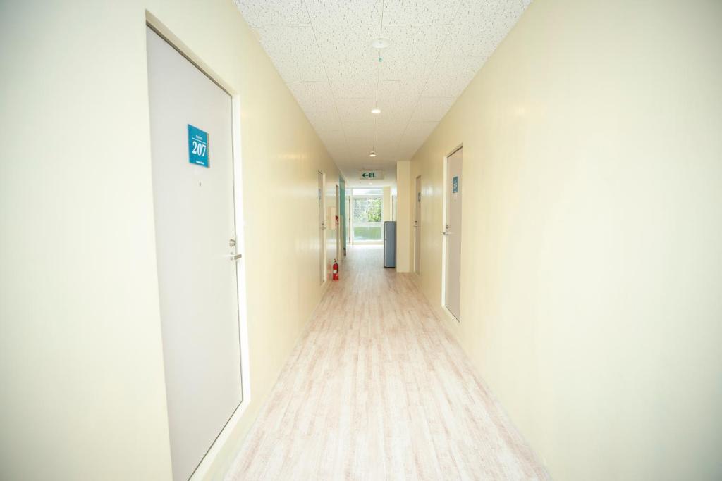 an empty corridor of a hospital with a hallway at kamekamehouse in Tokashiki