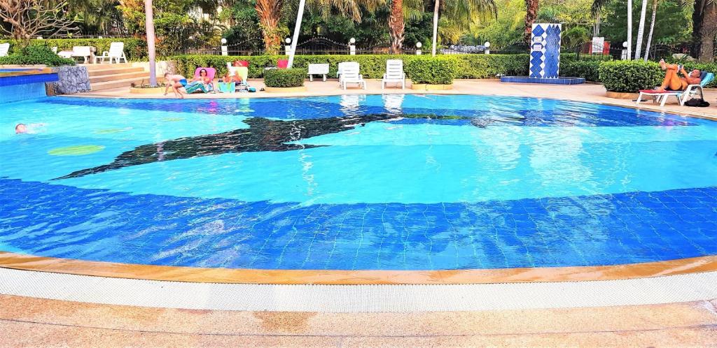 a large swimming pool with blue water at View Talay 2A sea view apartment Pattaya in Jomtien Beach