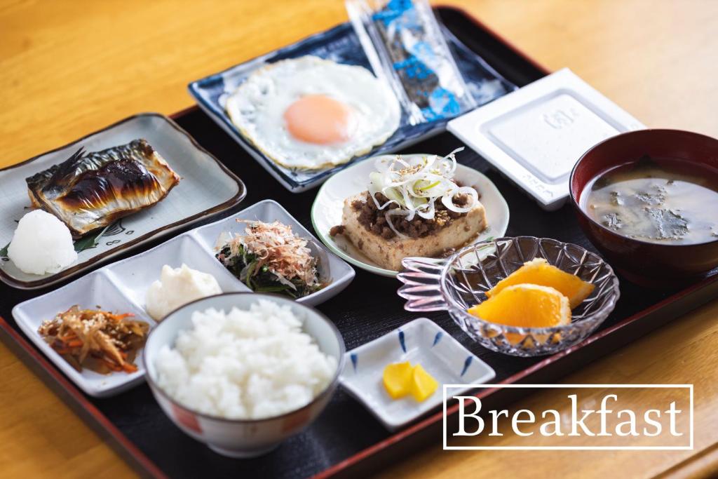 a tray with different types of food on a table at kamekamehouse in Tokashiki