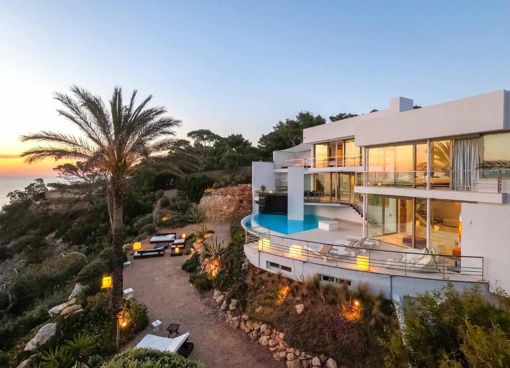 an aerial view of a house with the ocean at VILLA VADELLA in Cala Vadella