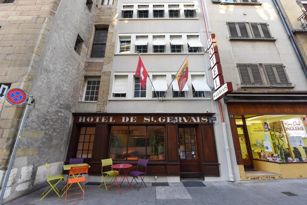 a store with chairs in front of a building at Hotel St. Gervais in Geneva