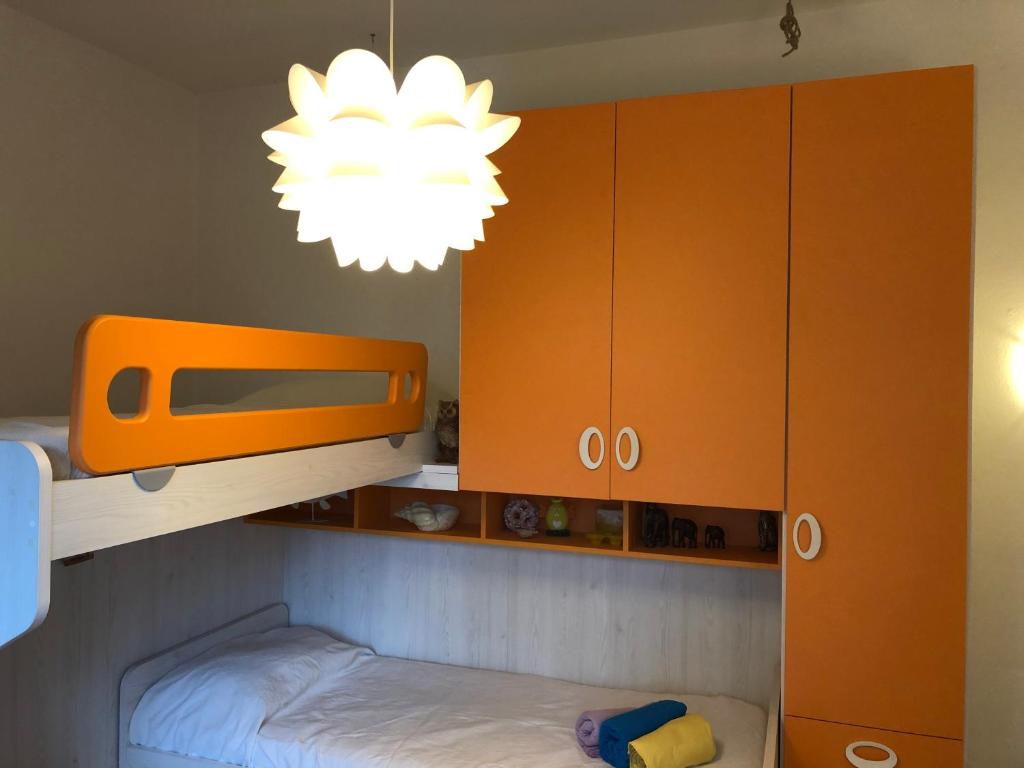 a bedroom with a bunk bed and a chandelier at Ca' Adriana in Lido di Jesolo
