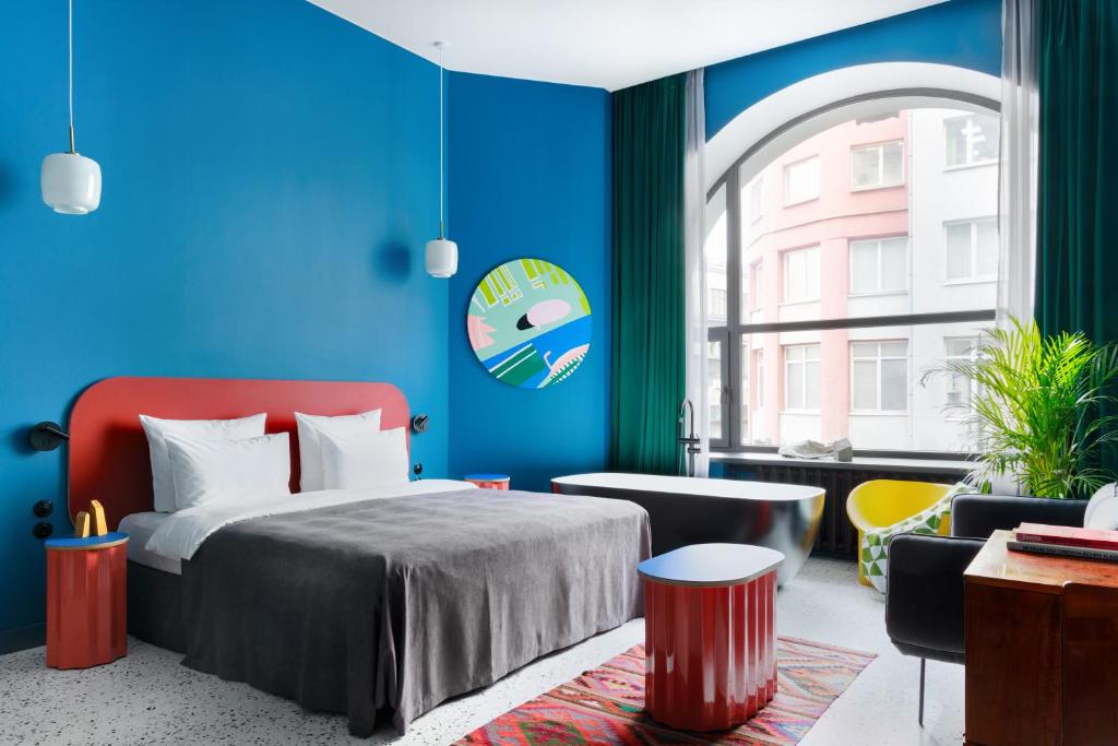 a bedroom with a bed and a blue wall at P17 Hotel in Moscow