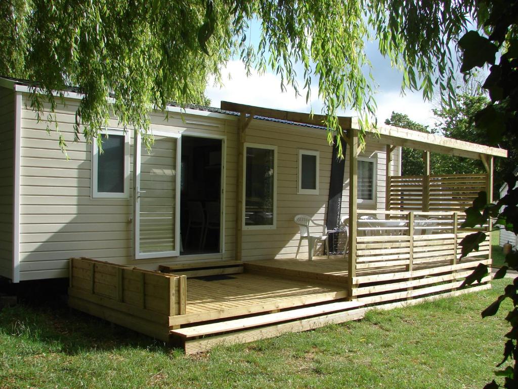 a front porch of a house with a deck at Camping Au Coeur de Vendome in Vendôme