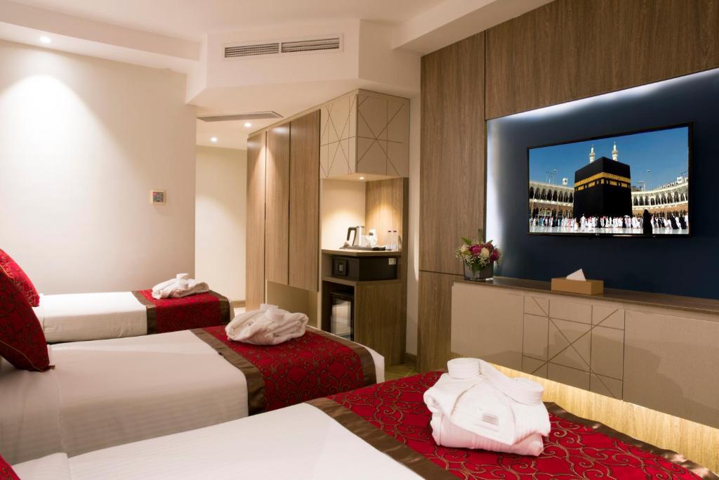 Postel nebo postele na pokoji v ubytování Hibatullah Hotel Makkah