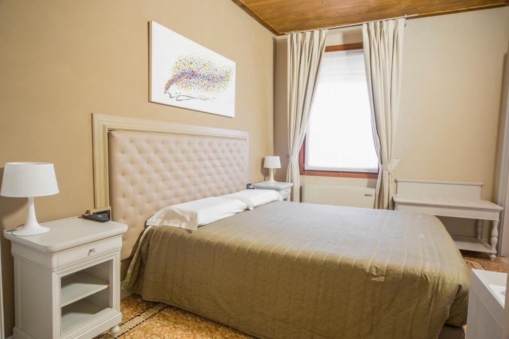 1 dormitorio con cama y ventana en Torre Soave - Locazione Turistica, en Soave