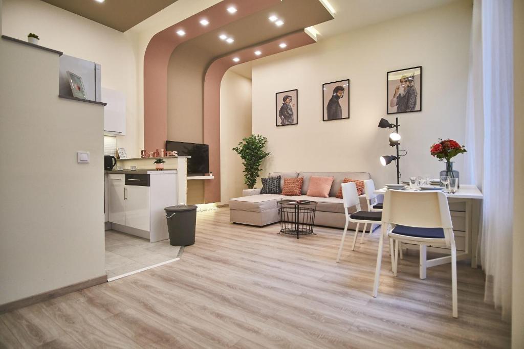 ein Wohnzimmer mit einem Sofa, einem Tisch und Stühlen in der Unterkunft F4 Design Apartment- Budapest in Budapest