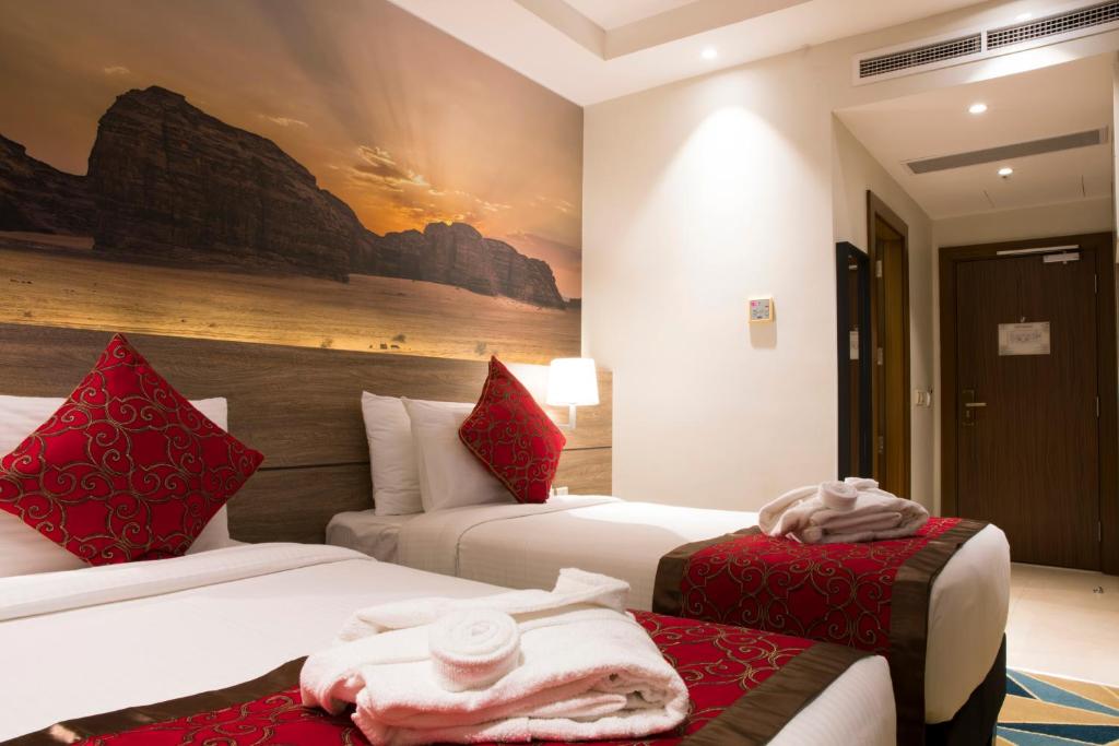 Postel nebo postele na pokoji v ubytování Hibatullah Hotel Makkah