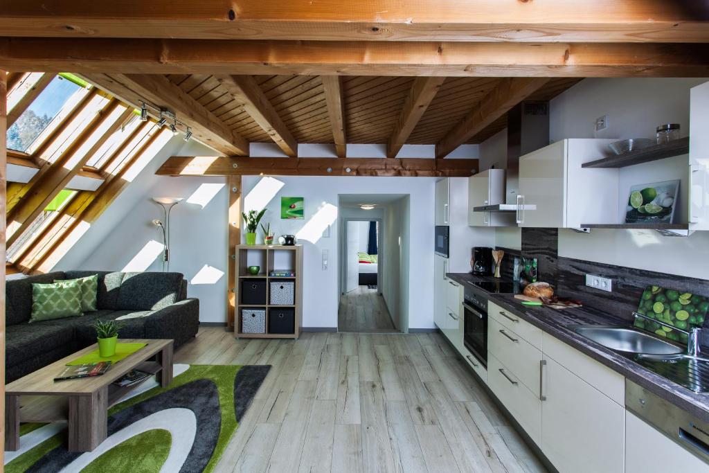 a kitchen and living room with a couch and a table at Ferienwohnungen Schwabenhof in Schramberg