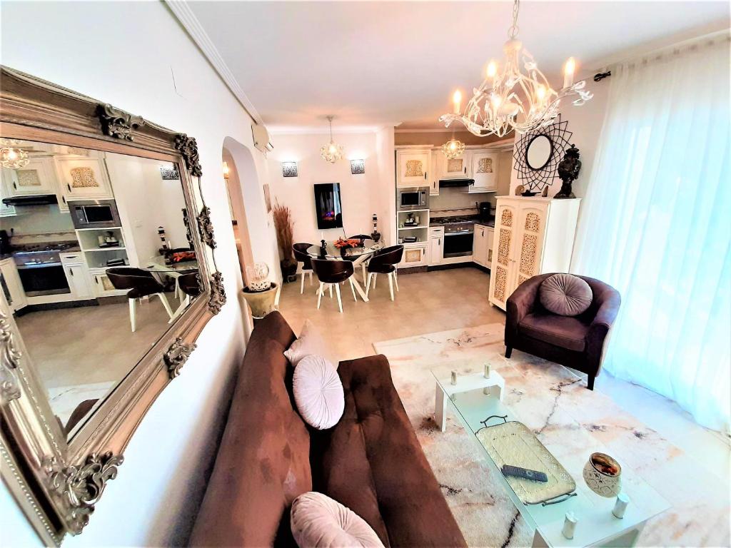 a living room with a couch and a dining room at Beach House - healthy, protected location! El Campello, Alicante, Spain in El Campello