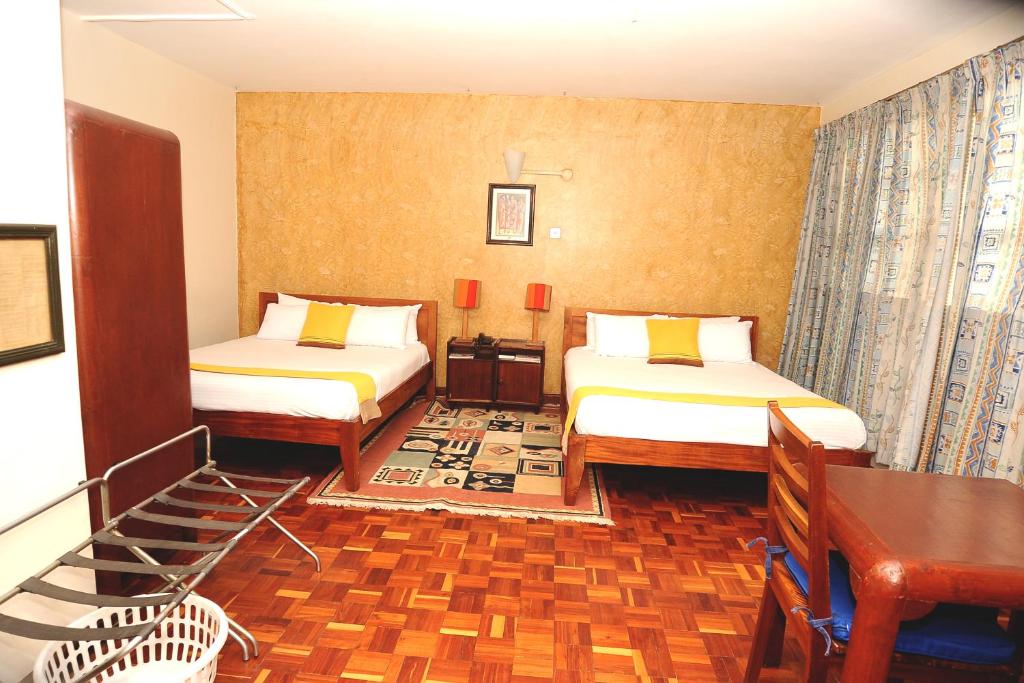 Postel nebo postele na pokoji v ubytování Kenya Comfort Hotel