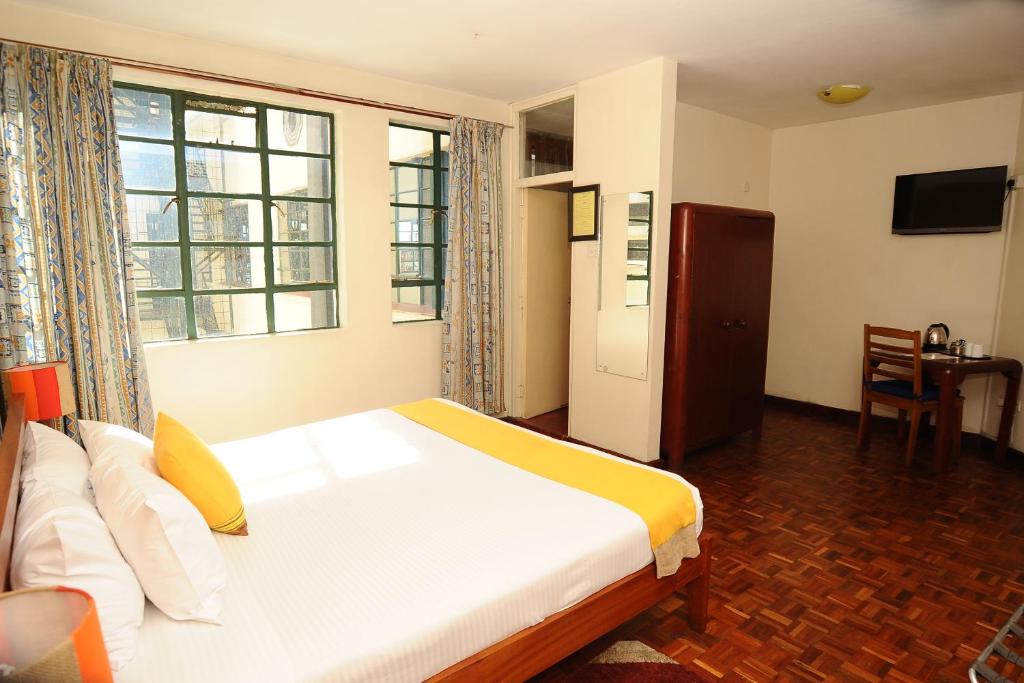 Postel nebo postele na pokoji v ubytování Kenya Comfort Hotel