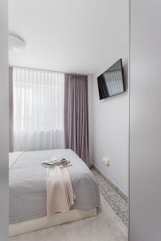 Postel nebo postele na pokoji v ubytování VISIONAPARTMENTS Lucerne - contactless check-in
