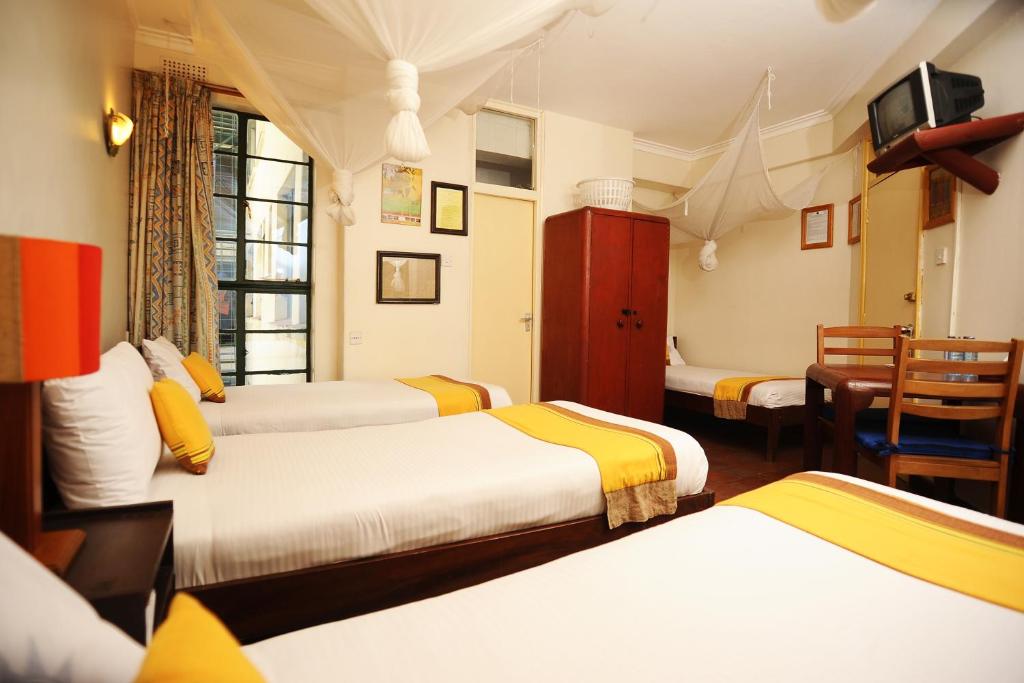Postel nebo postele na pokoji v ubytování Kenya Comfort Hotel