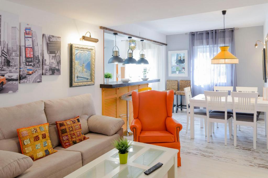 a living room with a couch and a dining room at Mezquita Apart. with Free Parking in Córdoba