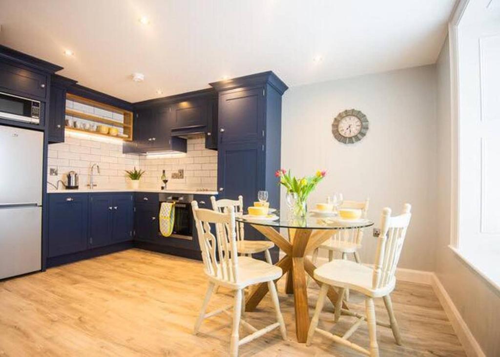 a kitchen and dining room with a table and chairs at Church Lane Holiday Home, Warrenpoint in Warrenpoint