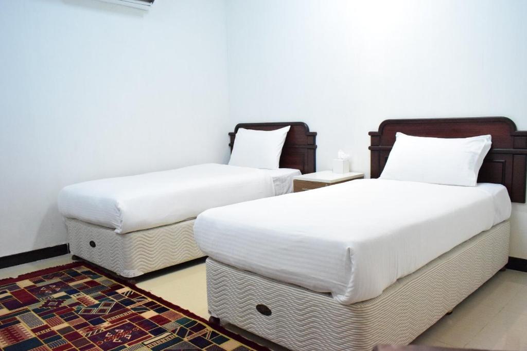 Voodi või voodid majutusasutuse Al Taraf Hotel Apartment toas