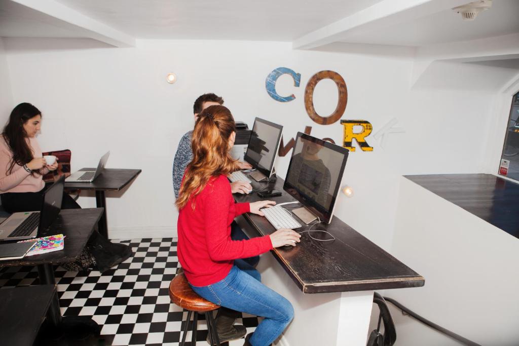 a woman sitting at a desk with a computer at City Backpackers Hostel in Stockholm