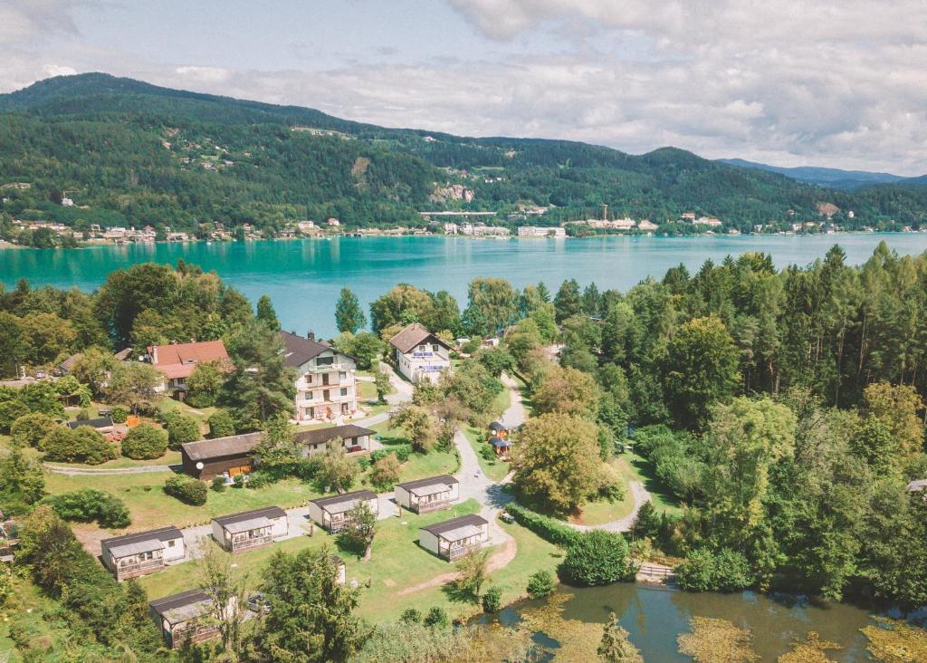 an aerial view of a house next to a lake at EuroParcs Wörthersee in Schiefling am See