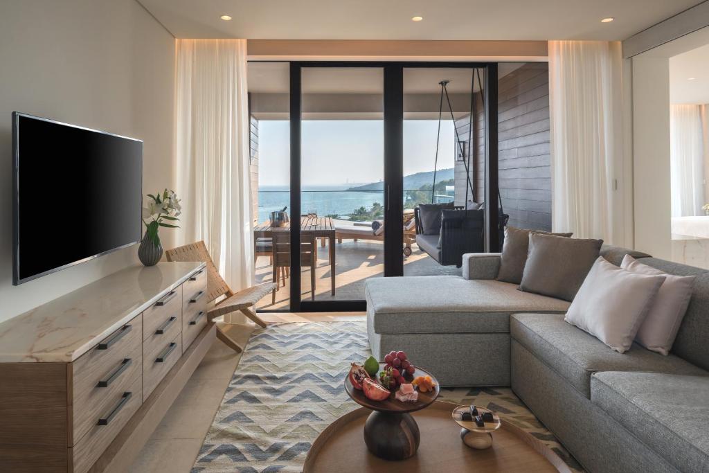 a living room with a tv and a couch and a table at Amara - Sea Your Only View™ in Limassol