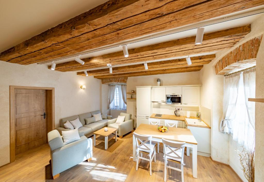 a kitchen and living room with a table and chairs at Residence Terčino Údolí in Nové Hrady