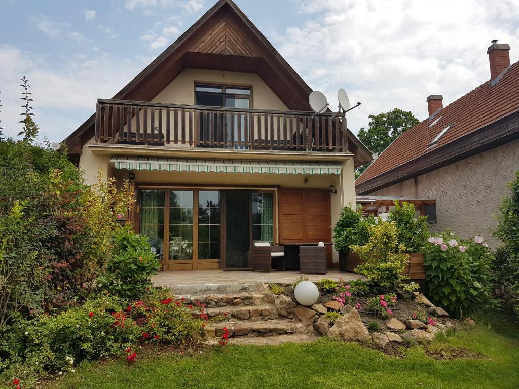 a house with a balcony on top of it at Dália Ház in Velence