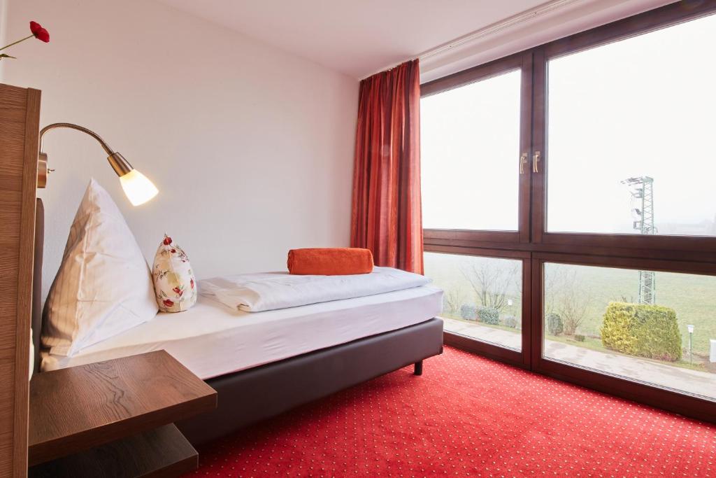 Postel nebo postele na pokoji v ubytování Hotel Schoos