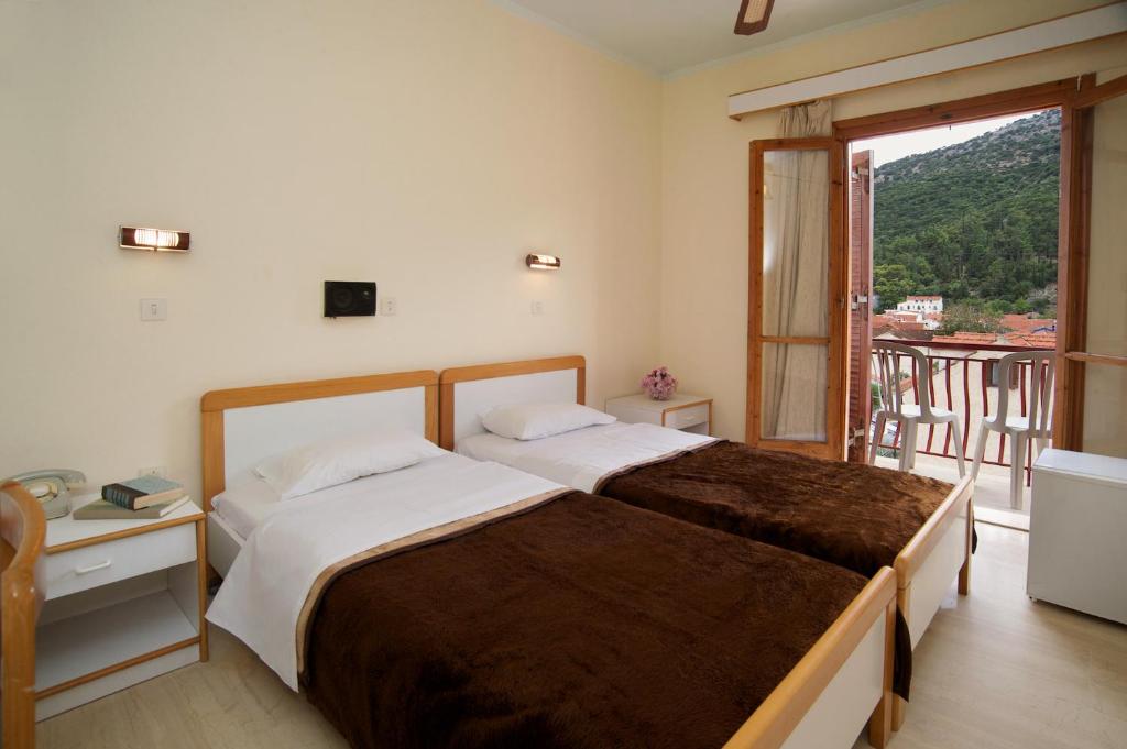 Postel nebo postele na pokoji v ubytování Moustakis Hotel