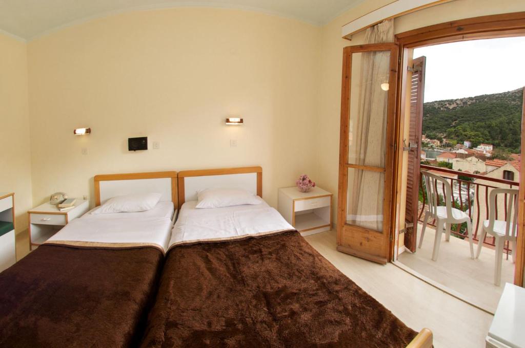 Postel nebo postele na pokoji v ubytování Moustakis Hotel