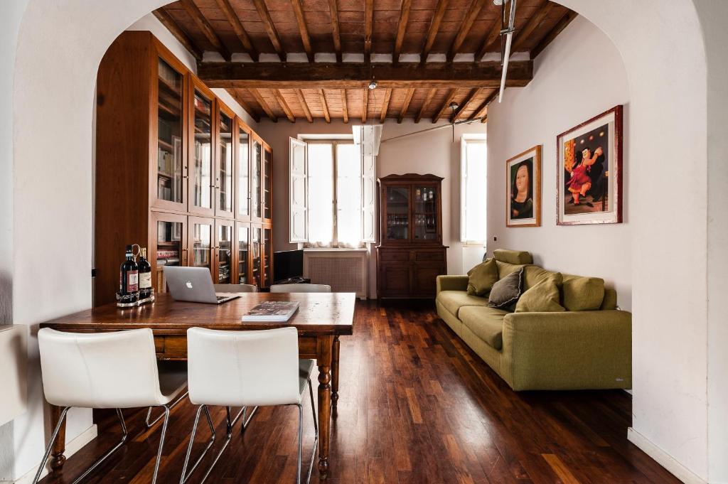 a living room with a table and a couch at The Galileo Apartment in Pisa