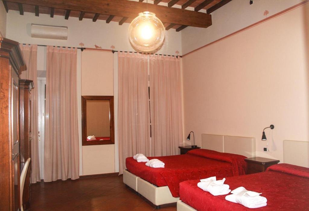 a bed room with two beds and two lamps at B&B Il Seminario in Lucca