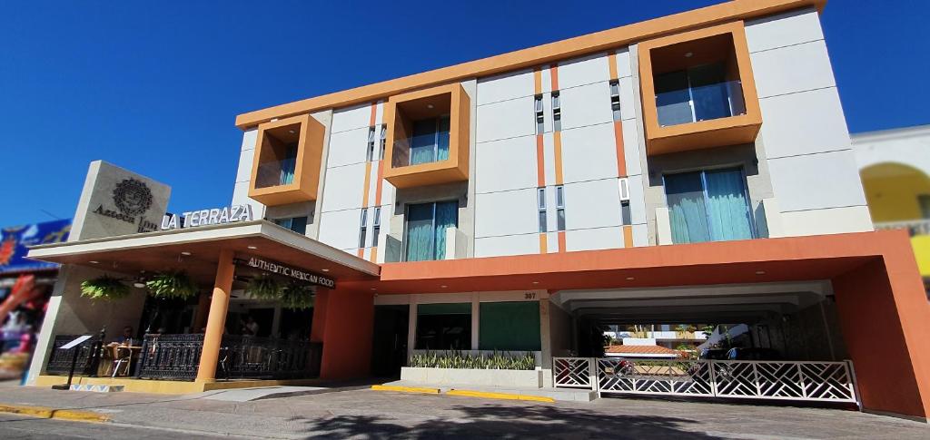 a building with a parking garage in front of it at Hotel Azteca Inn in Mazatlán