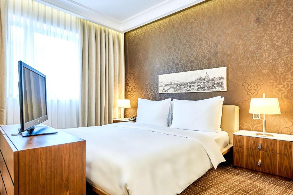 a hotel room with a bed and a television at Radisson Blu Hotel, Kyiv Podil City Centre in Kyiv