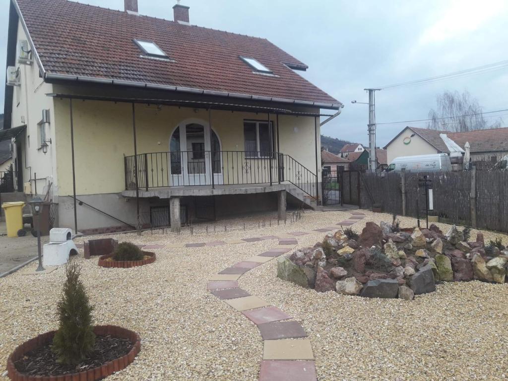 a house with a walkway in front of a yard at Tokaj vendégház in Tokaj