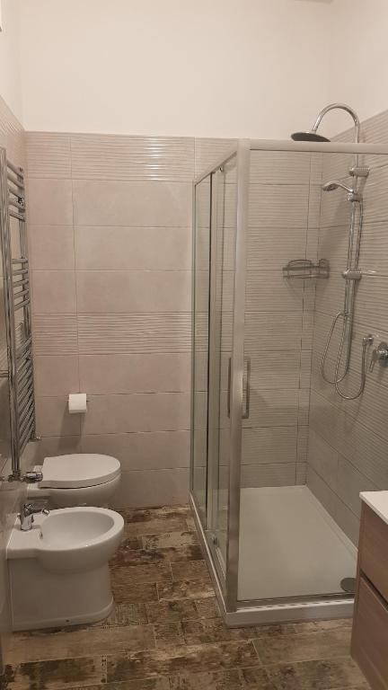 a bathroom with a shower and a toilet and a sink at THAT'S AMORE FIUMICINO Airport in Fiumicino