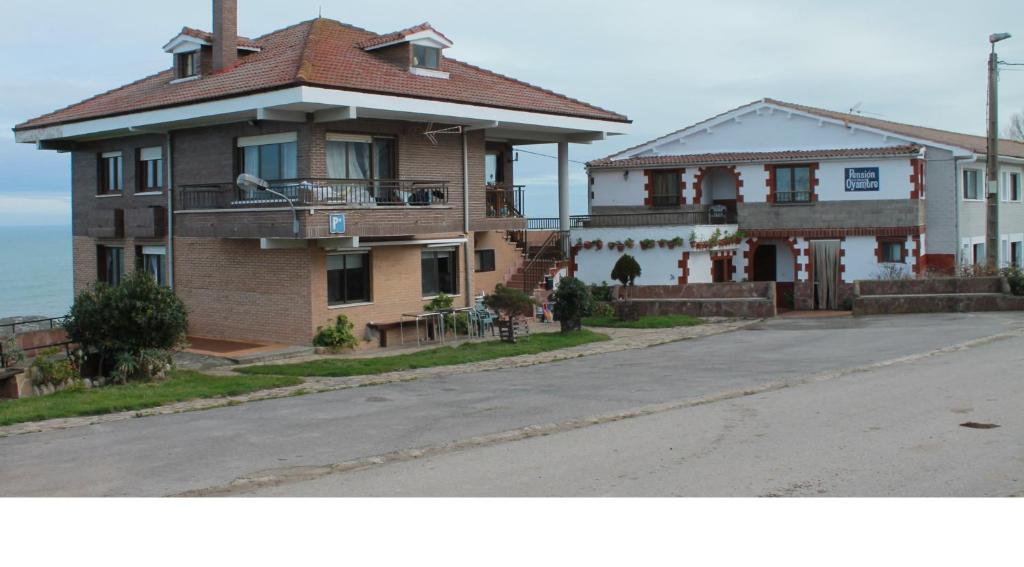 a house on the side of a street at Pensión Oyambre in San Vicente de la Barquera