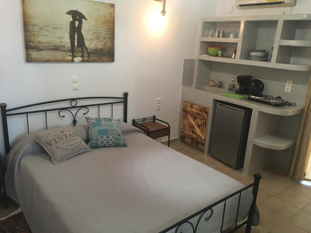 a bedroom with a bed with a person holding an umbrella at Pension Irene 1 in Naxos Chora