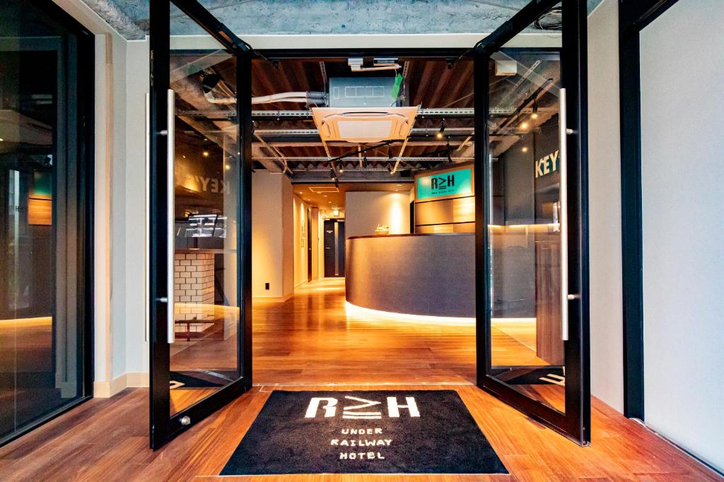 a room with glass doors and a rug on the floor at UNDER RAILWAY HOTEL AKIHABARA in Tokyo