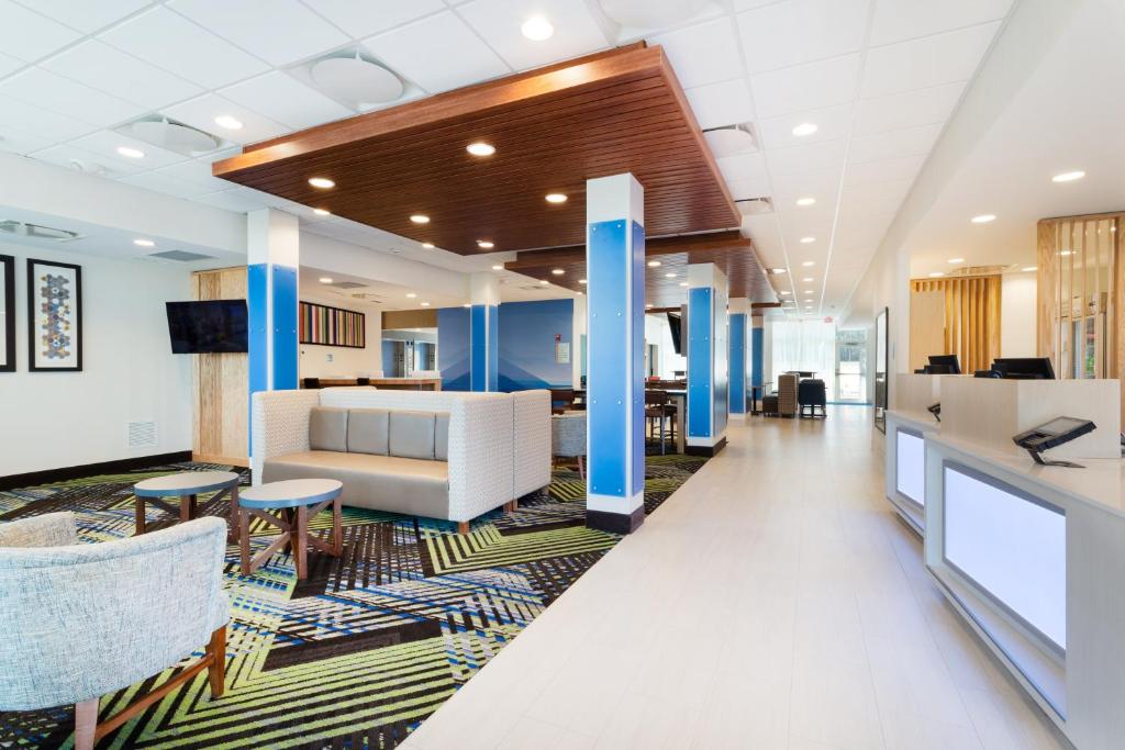 an office lobby with white furniture and blue columns at Holiday Inn Express & Suites Niceville - Eglin Area, an IHG Hotel in Niceville