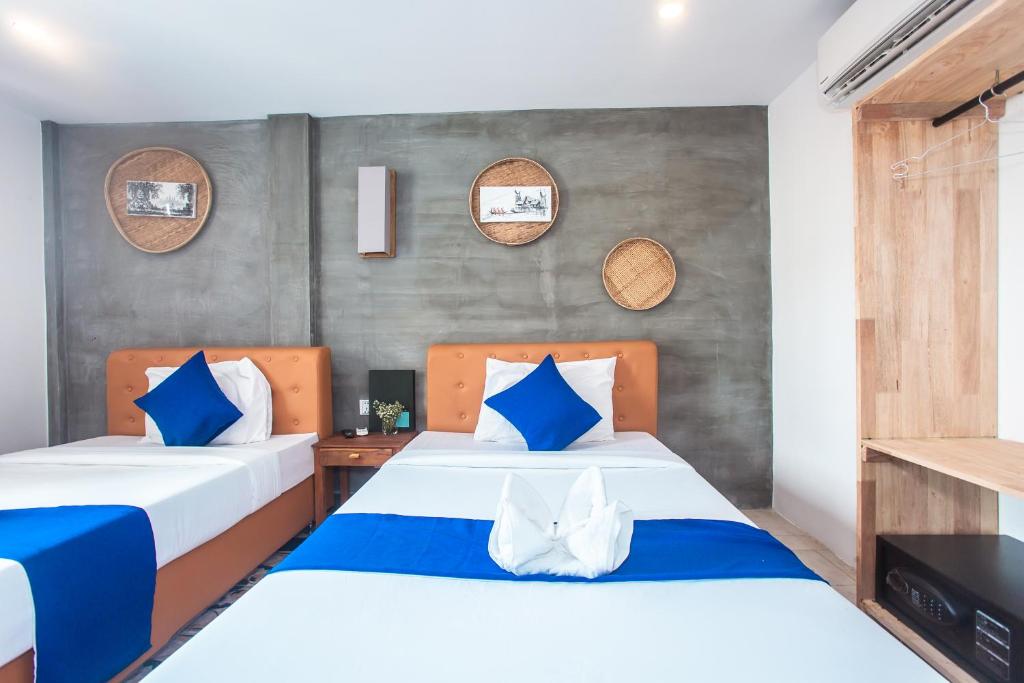 Postel nebo postele na pokoji v ubytování Grand Elevation Hotel