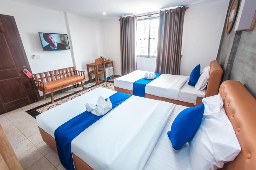 Postel nebo postele na pokoji v ubytování Grand Elevation Hotel