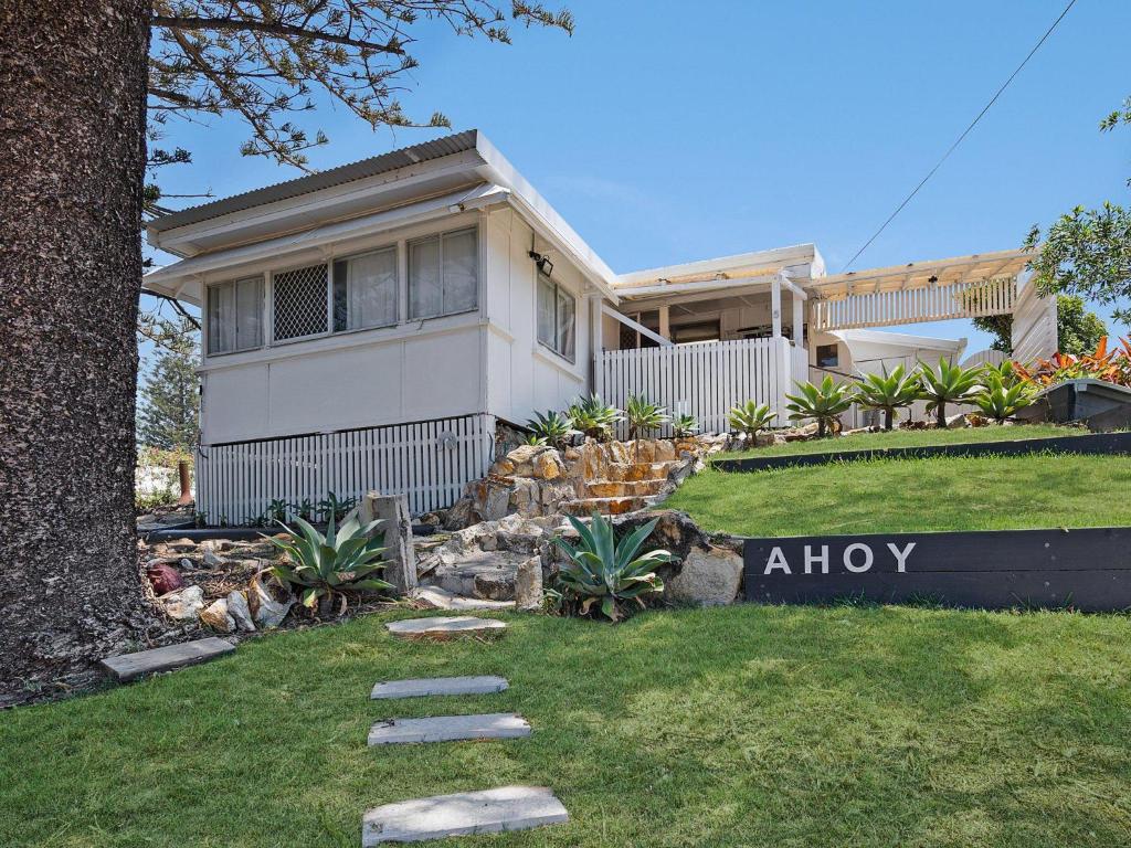 a house with a sign in front of it at Ahoy Cottage in Point Lookout