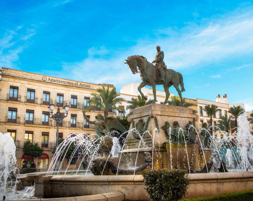 a statue of a man riding a horse in front of a fountain at Apartamentos Arenal in Jerez de la Frontera