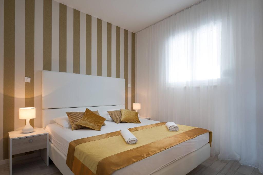 Postel nebo postele na pokoji v ubytování Perla Resort
