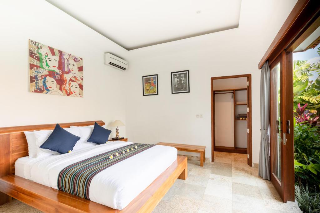Postel nebo postele na pokoji v ubytování Sawah Villas