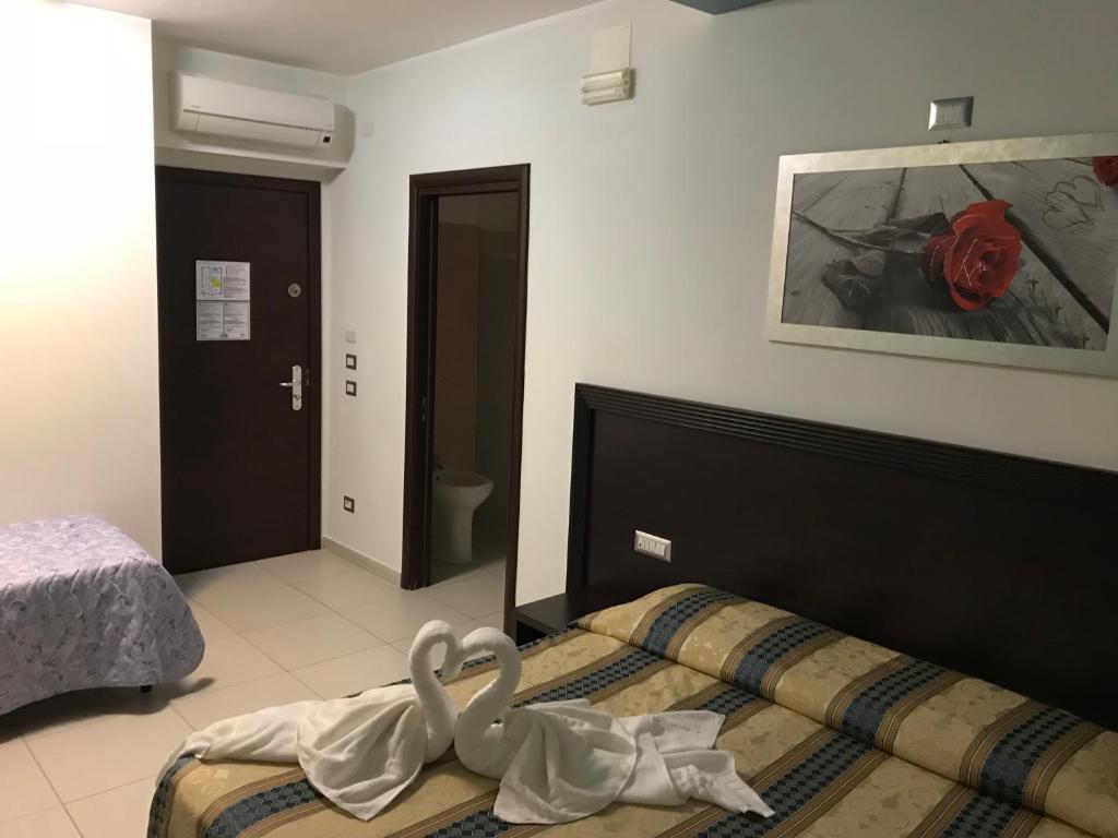 Postel nebo postele na pokoji v ubytování Hotel La Rosetta Scauri