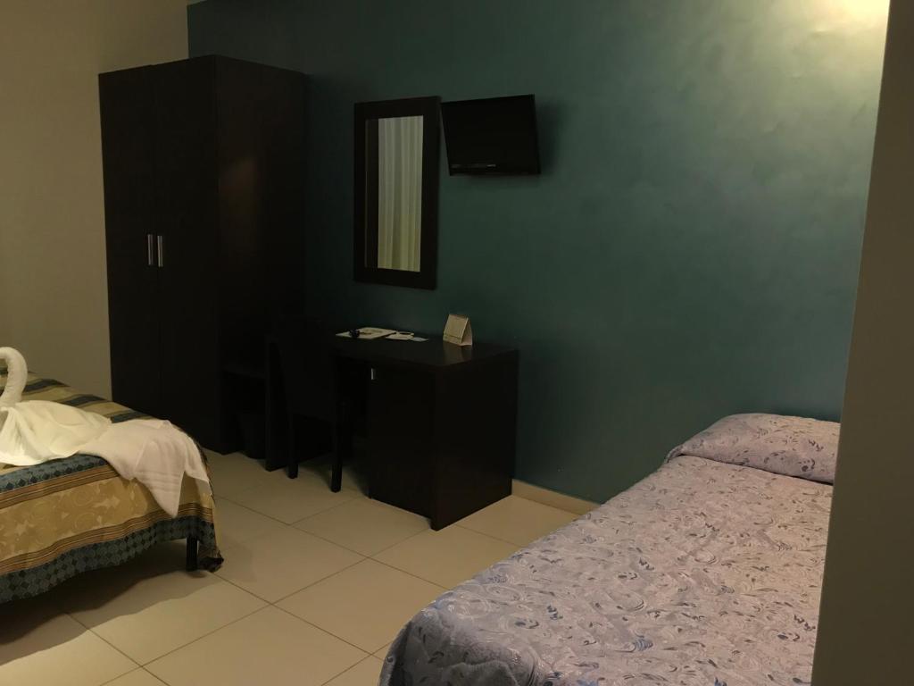 Postel nebo postele na pokoji v ubytování Hotel La Rosetta Scauri