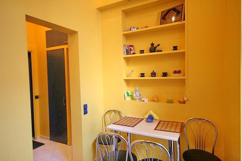 a dining room with a white table and chairs at Park and Opera Apartments in Lviv